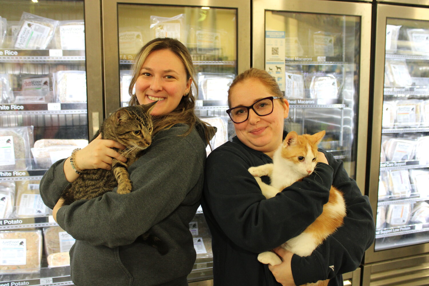 Volunteer organizers Jordyn Valente, 30, and Ally Tyrell, 25, with Fin and Rosco, two 8-month-old cats that are looking for new homes.